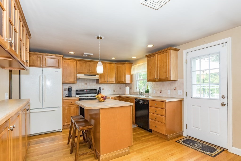 2 Marilyn Road Billerica, MA 01821 - Photo 6 of 32 a kitchen with a stove a refrigerator and a stove top oven
