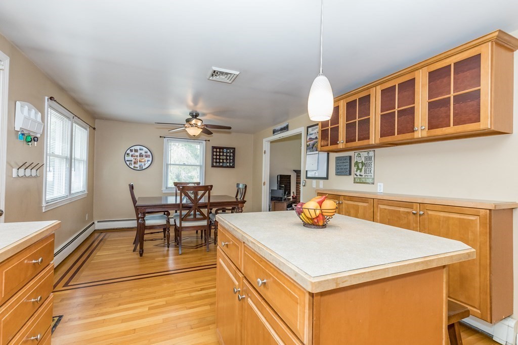 2 Marilyn Road Billerica, MA 01821 - Photo 9 of 32 a kitchen with a table chairs and a stove