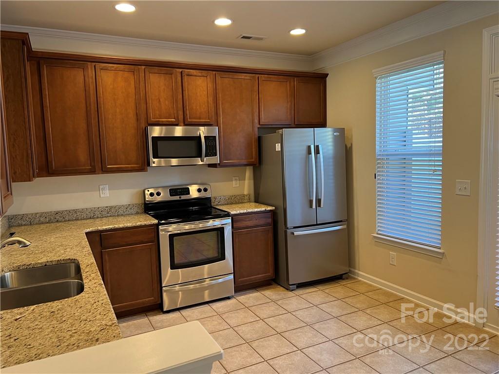 2016 Aston Mill Place Charlotte, NC 28273 - Photo 5 of 13 a kitchen with granite countertop wooden cabinets and stainless steel appliances