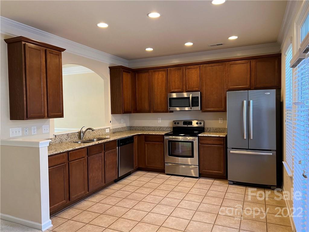 2016 Aston Mill Place Charlotte, NC 28273 - Photo 6 of 13 a kitchen with stainless steel appliances granite countertop a refrigerator sink and stove