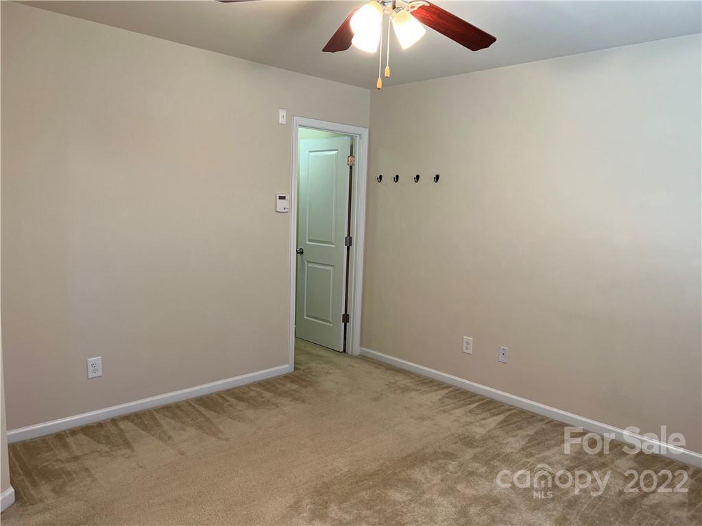 2016 Aston Mill Place Charlotte, NC 28273 - Photo 9 of 13 an empty room with a fan & a ceiling fan