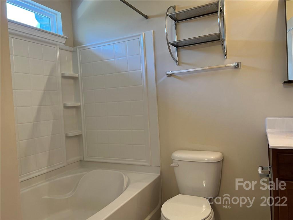 2016 Aston Mill Place Charlotte, NC 28273 - Photo 10 of 13 a white toilet sitting next to a bath tub