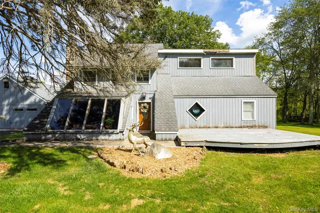 a house that has a tree in front of it