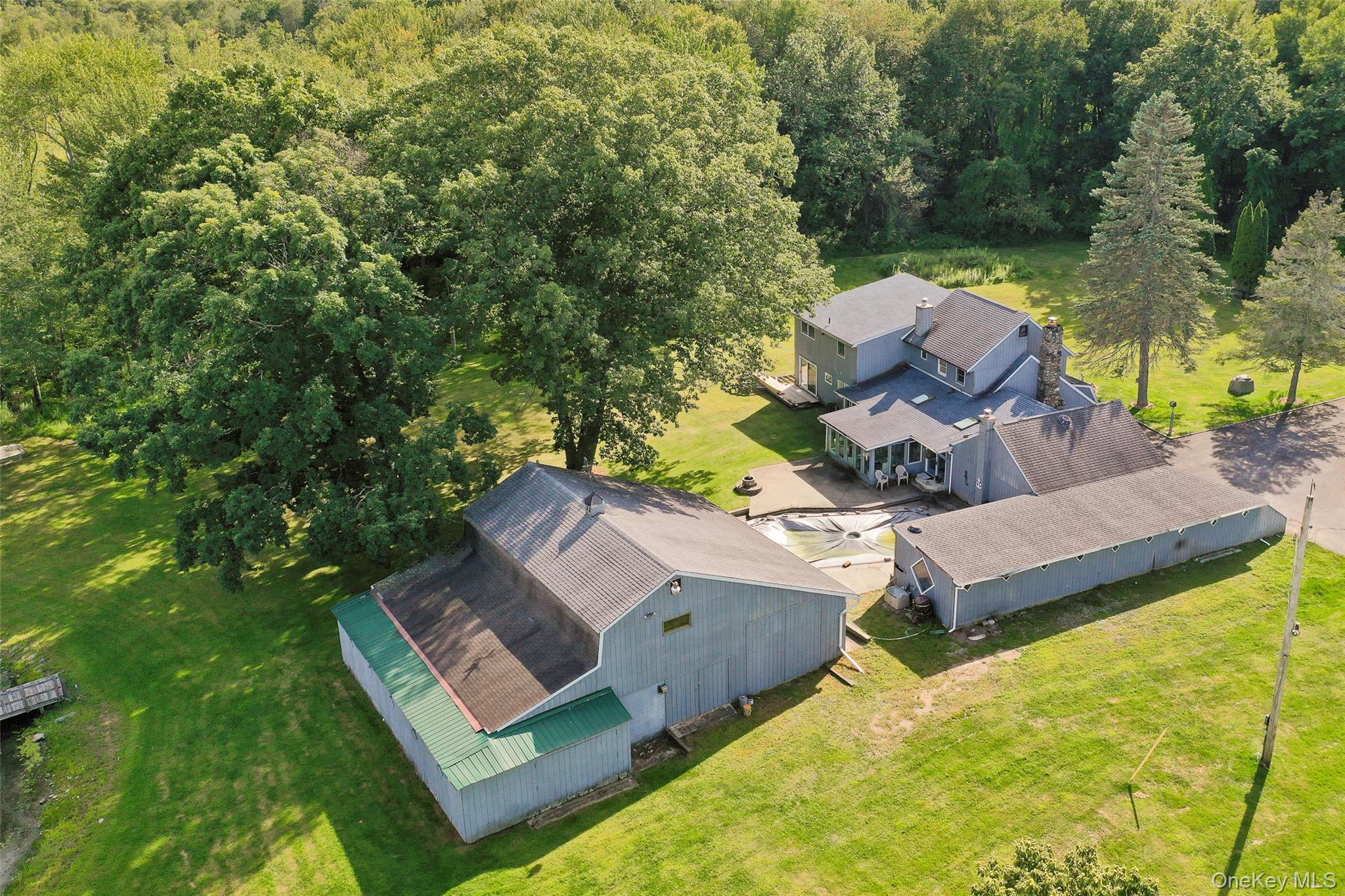 89 Deer Pond Road Verbank, NY 12585 - Photo 9 of 40 an aerial view of a house with swimming pool garden and trees
