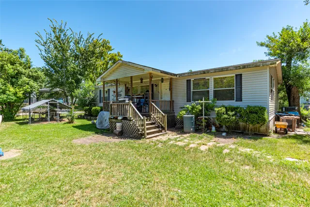 a view of a house with backyard porch and sitting area