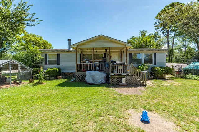 a view of a house with backyard porch and sitting area