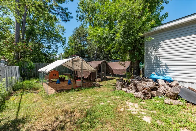a backyard of a house with barbeque oven and outdoor seating
