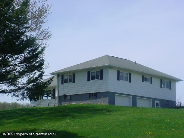Rr Springville, PA 18844 - Photo 1 of 9 a front view of a house with a garden