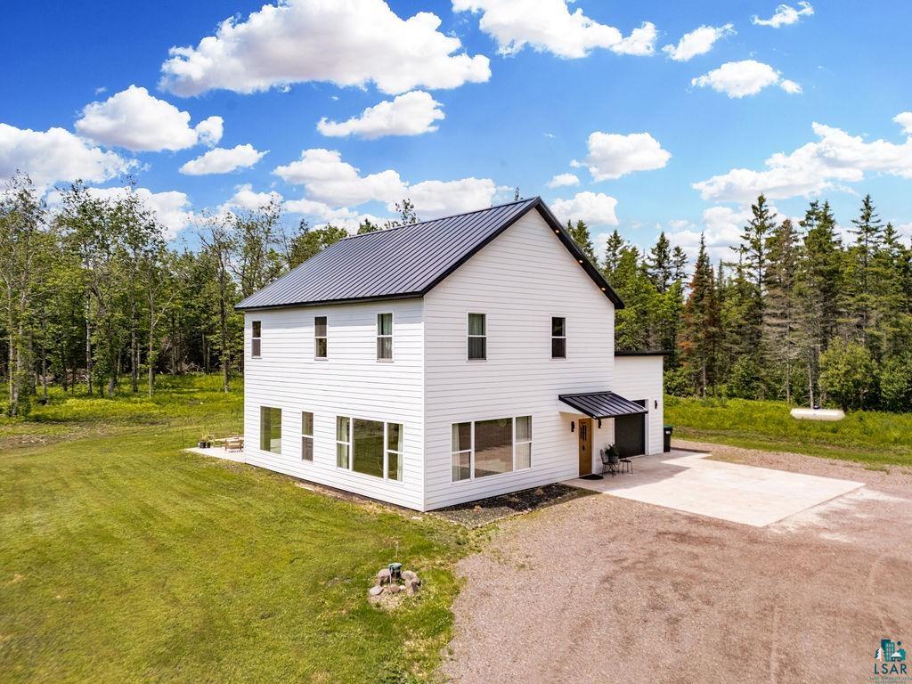 Modern Traditional 3 bedroom/4 bath with durable LP white lap siding and long lasting dark metal roof all nestled on 8 beautiful acres.
