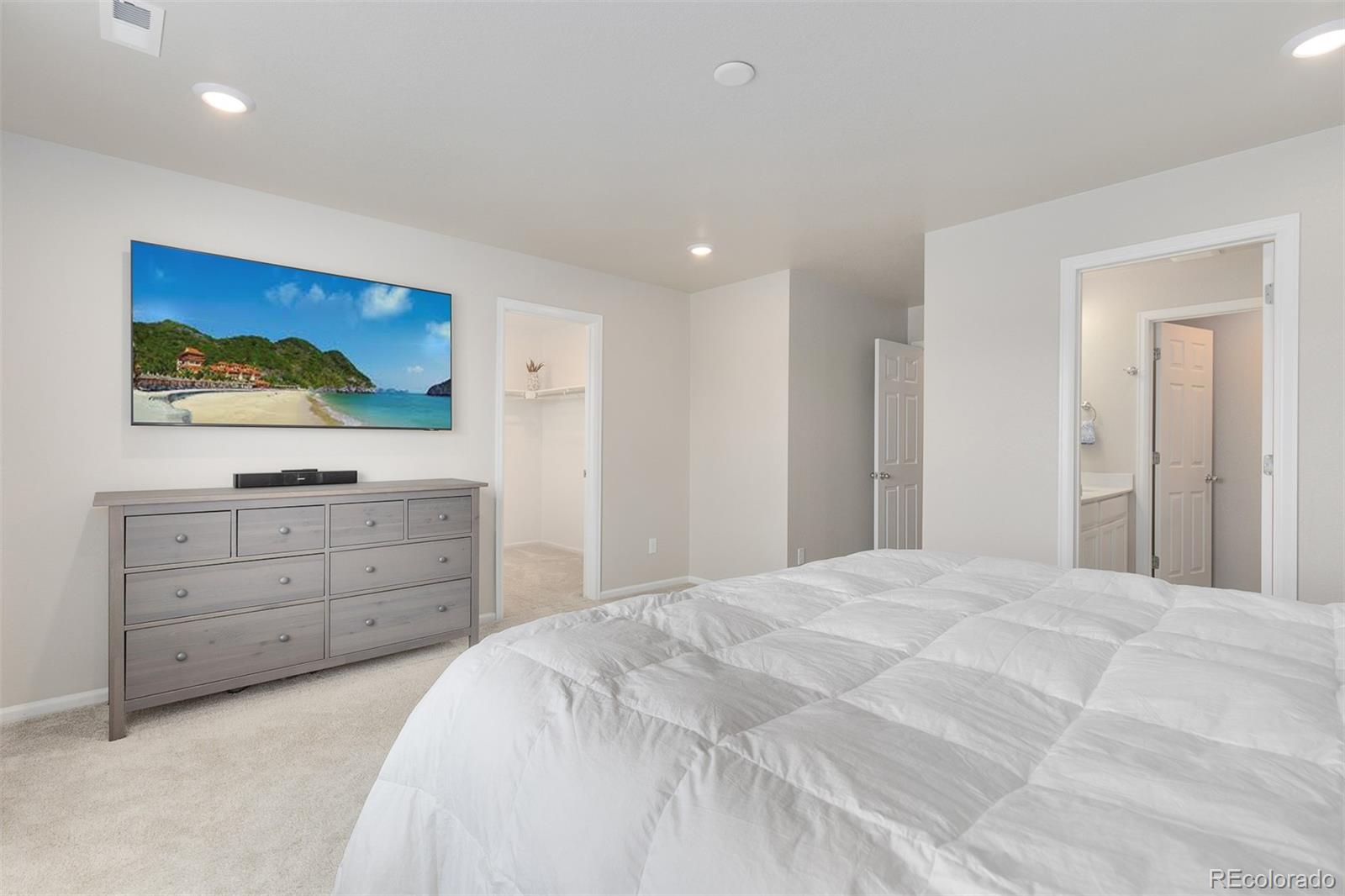 7199 Othello Street Castle Pines, CO 80108 - Photo 12 of 28 a bedroom with a bed and a dresser