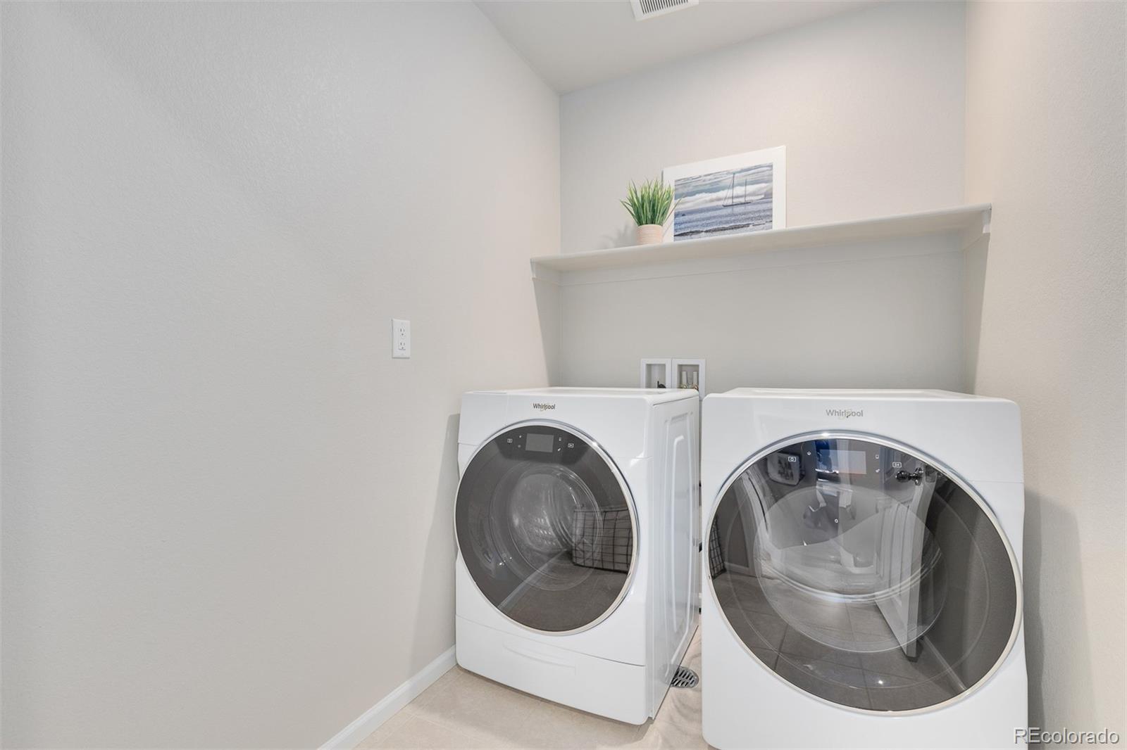 7199 Othello Street Castle Pines, CO 80108 - Photo 13 of 28 a utility room with dryer and washer