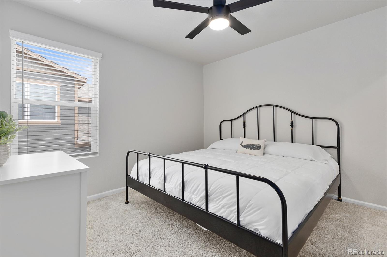 7199 Othello Street Castle Pines, CO 80108 - Photo 14 of 28 a bedroom with a bed and a window