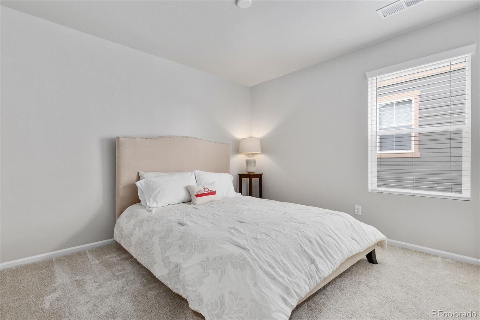 7199 Othello Street Castle Pines, CO 80108 - Photo 17 of 28 a bedroom with a bed and a window