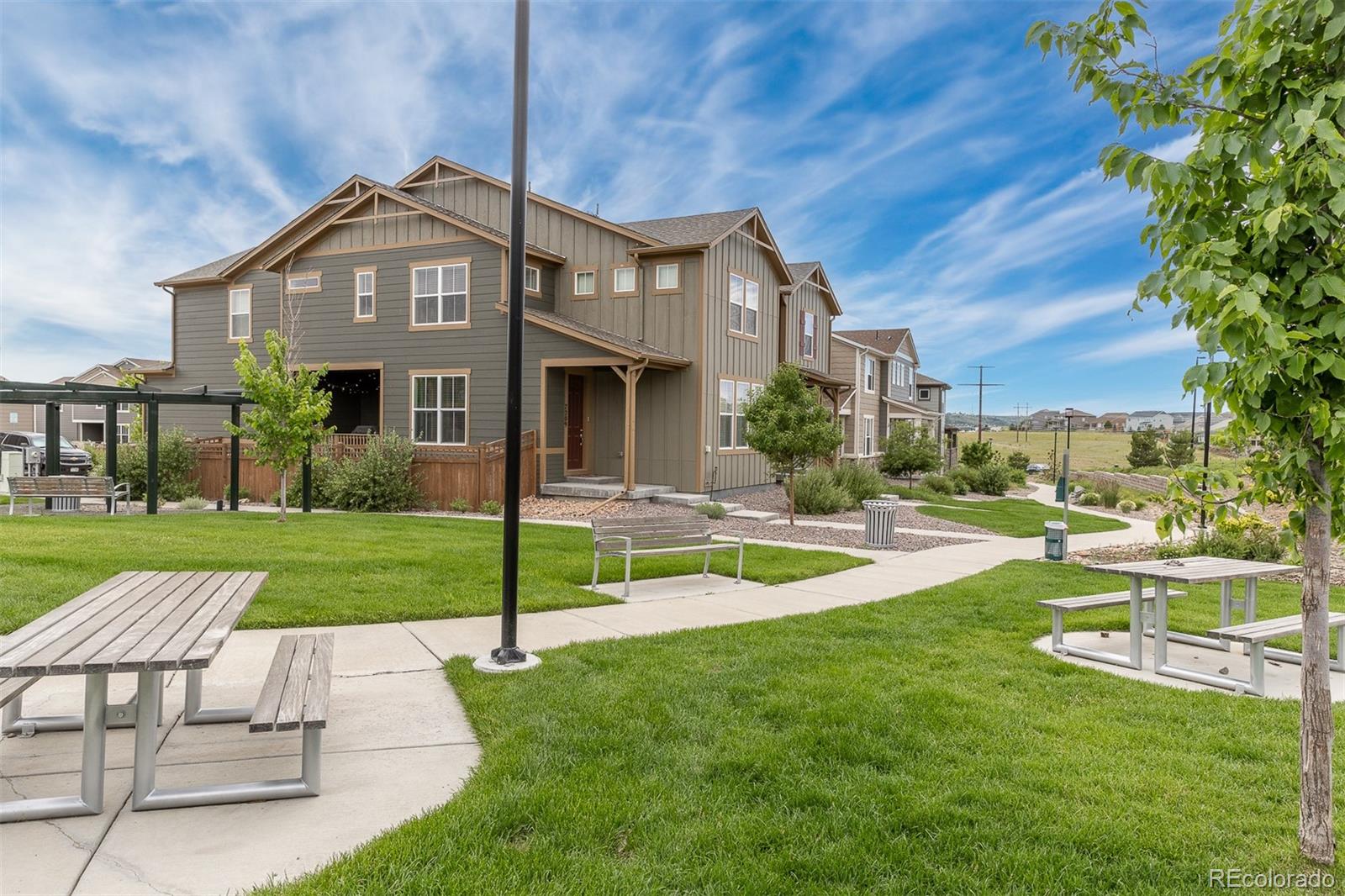7199 Othello Street Castle Pines, CO 80108 - Photo 26 of 28 a front view of a house with a yard