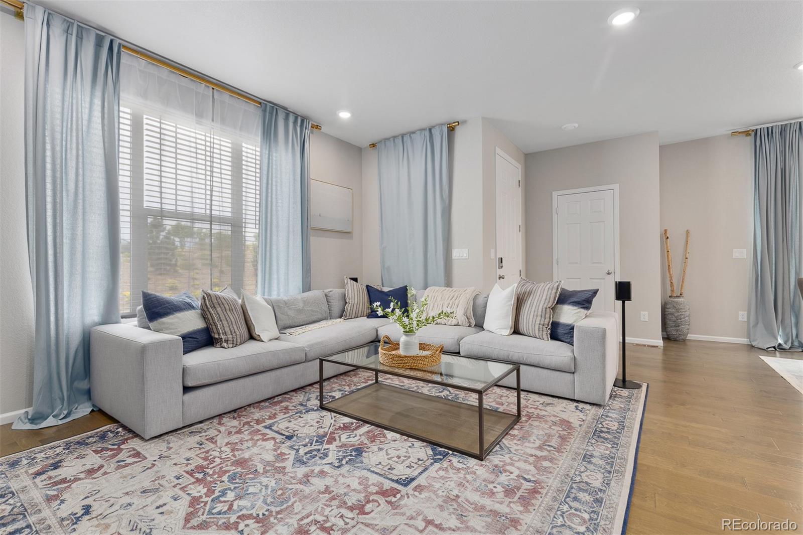 7199 Othello Street Castle Pines, CO 80108 - Photo 5 of 28 a living room with furniture and a large window