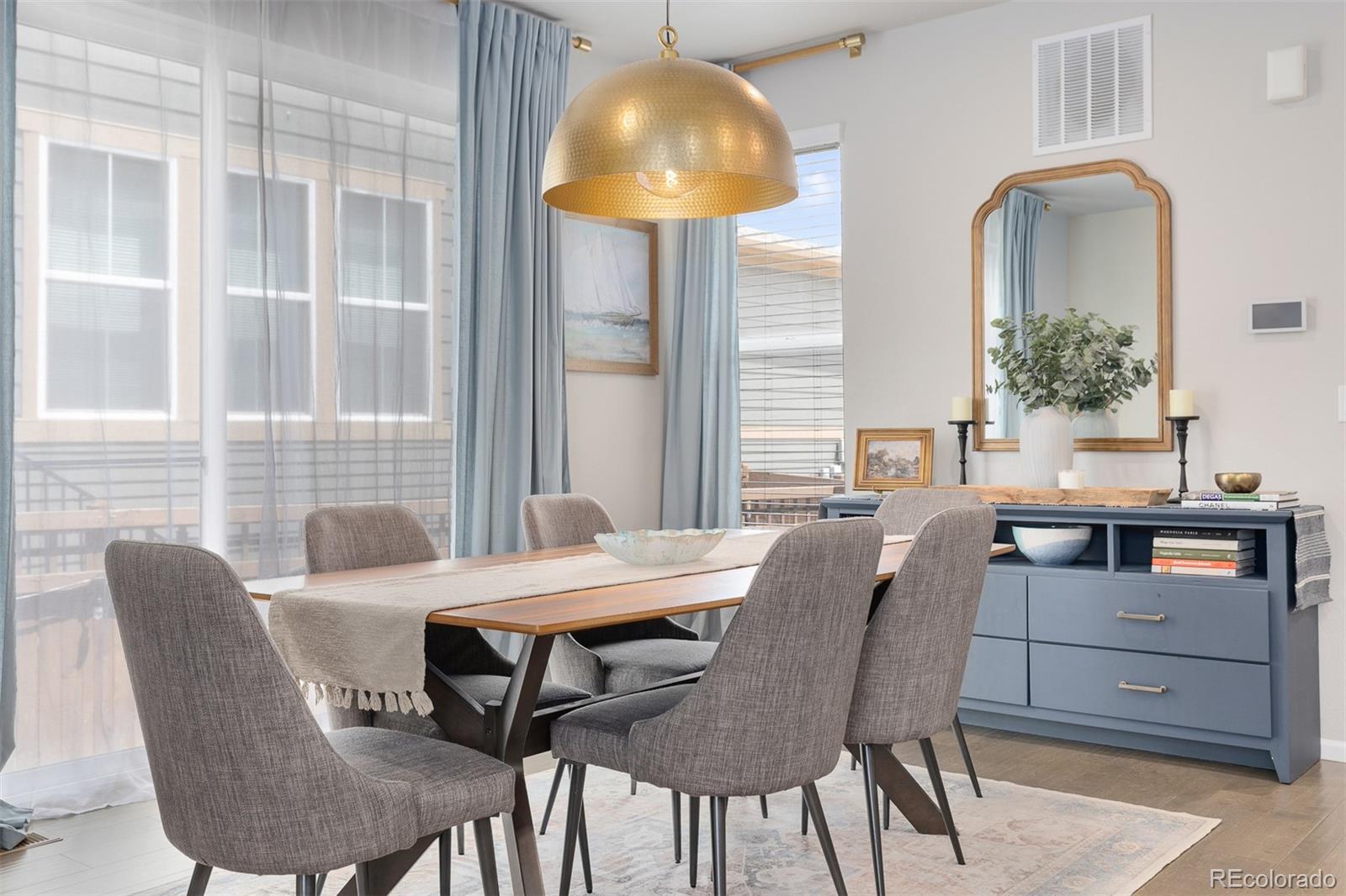 7199 Othello Street Castle Pines, CO 80108 - Photo 7 of 28 a view of a dining room with furniture and chandelier