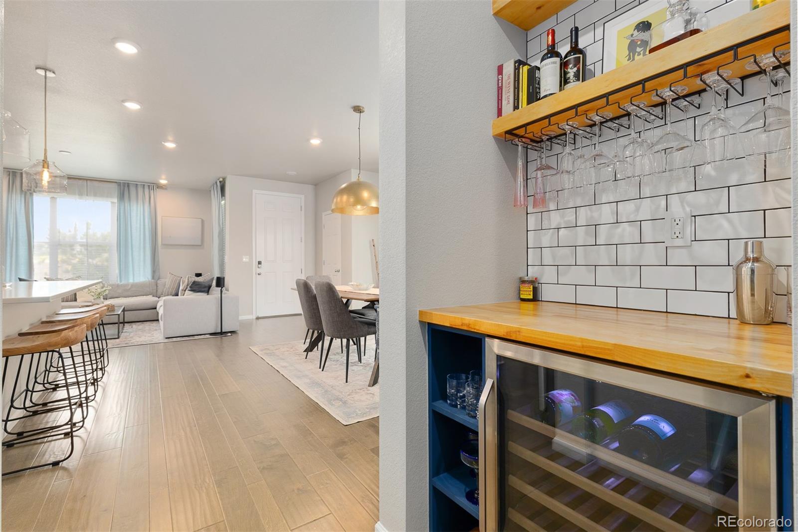 7199 Othello Street Castle Pines, CO 80108 - Photo 9 of 28 a view of a kitchen with a dining table and chairs