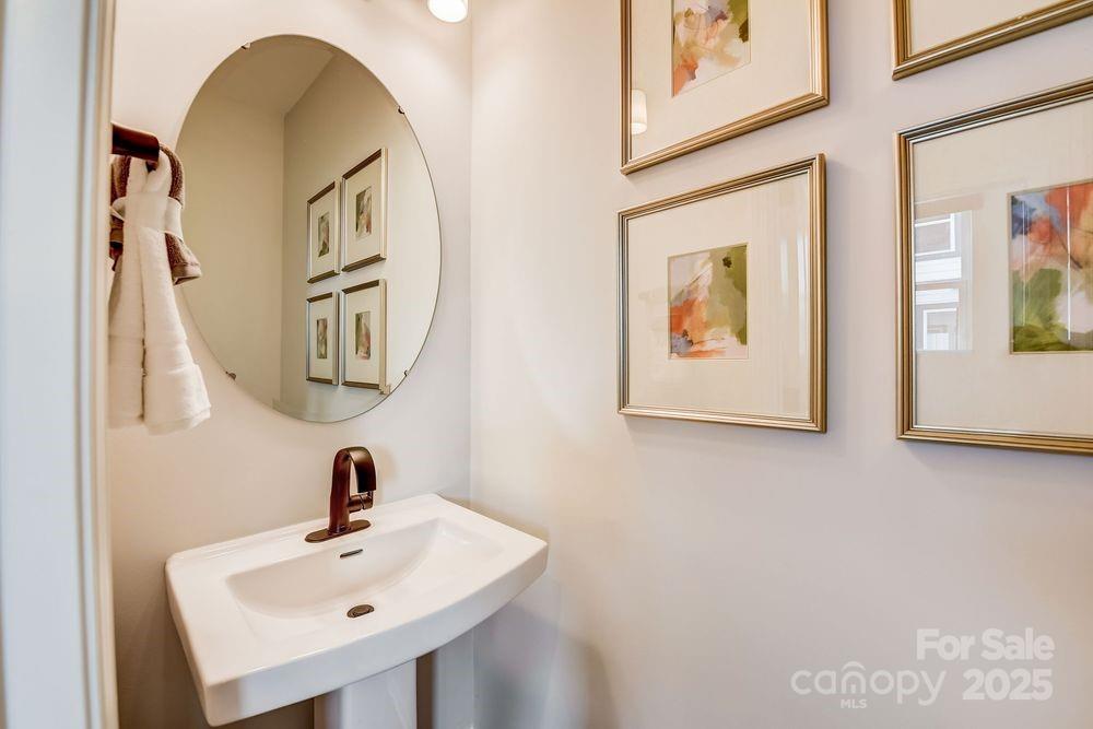 316 Catawba Avenue Davidson, NC 28036 - Photo 21 of 40 a bathroom with a sink and mirror