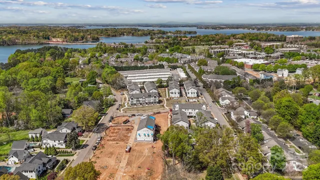 an aerial view of multiple houses with a yard
