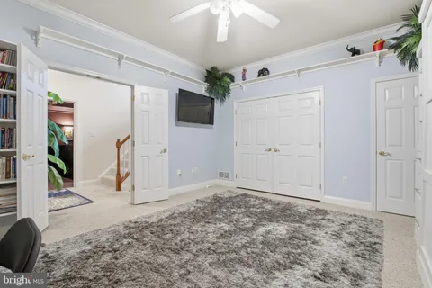 a spacious bedroom with a bed and a dresser
