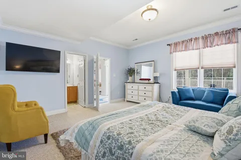 a room with a bed furniture and a large window