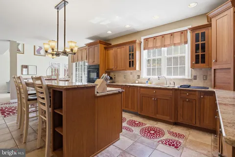 a kitchen with stainless steel appliances granite countertop a sink dishwasher stove and cabinets