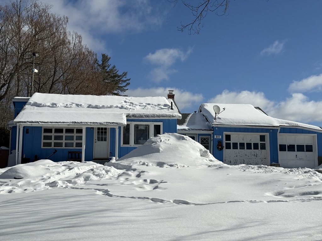 a view of a house with a snow in the background