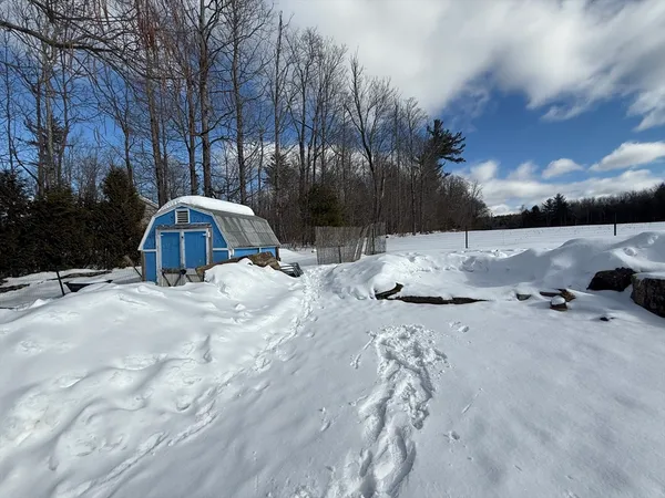 a view of roof with fire pit and trees around