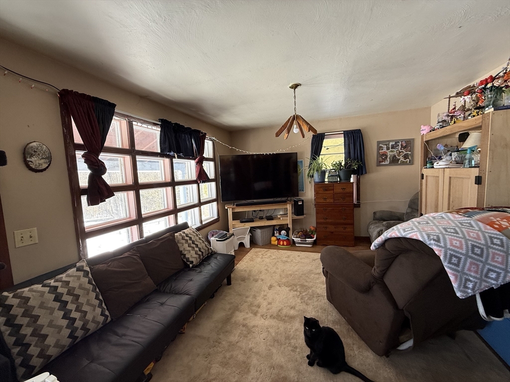 311 Cummington Road Ashfield, MA 01330 - Photo 4 of 12 a living room with furniture and a flat screen tv