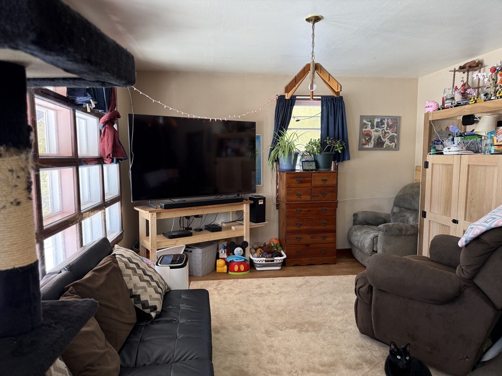 311 Cummington Road Ashfield, MA 01330 - Photo 5 of 12 a living room with furniture and a flat screen tv