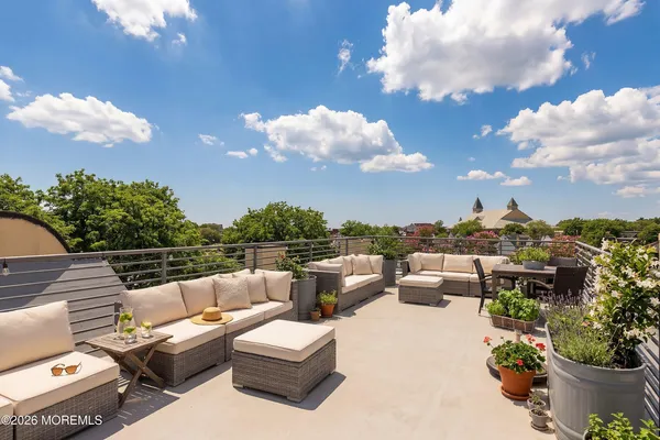 a view of a terrace with couches and a potted plant