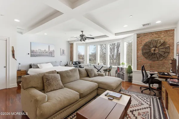 a living room with furniture and large windows