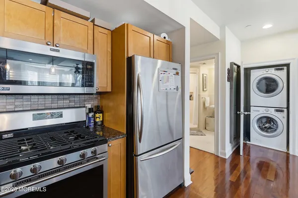 a kitchen with stainless steel appliances granite countertop a refrigerator and a stove