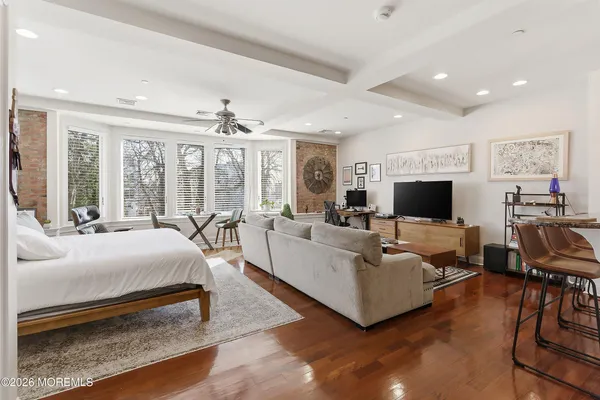 a spacious bedroom with a bed and large windows