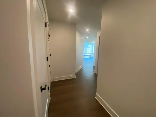 a view of an entryway with wooden floor