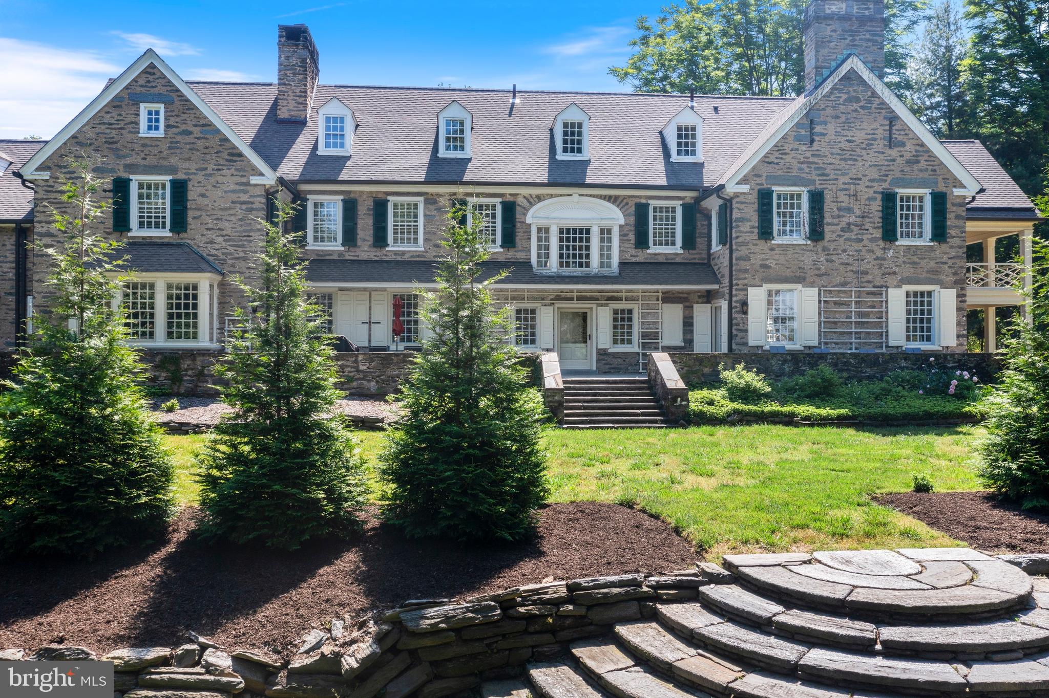 8201 Fenton Road Glenside, PA 19038 - Photo 31 of 86 a view of a brick house with a yard and potted plants