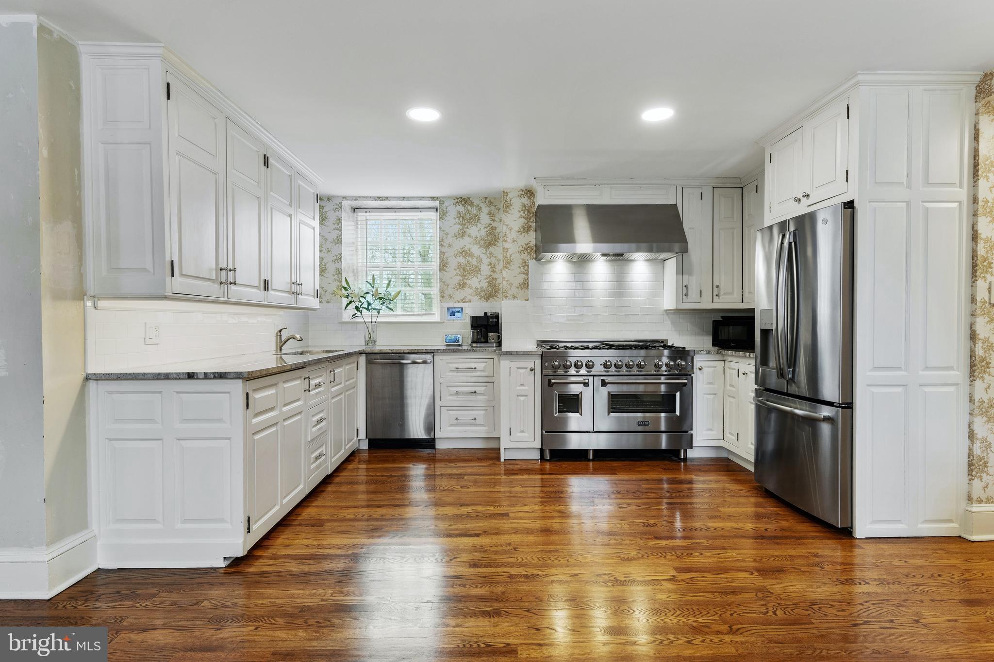 8201 Fenton Road Glenside, PA 19038 - Photo 54 of 86 a kitchen with granite countertop a refrigerator and a stove top oven