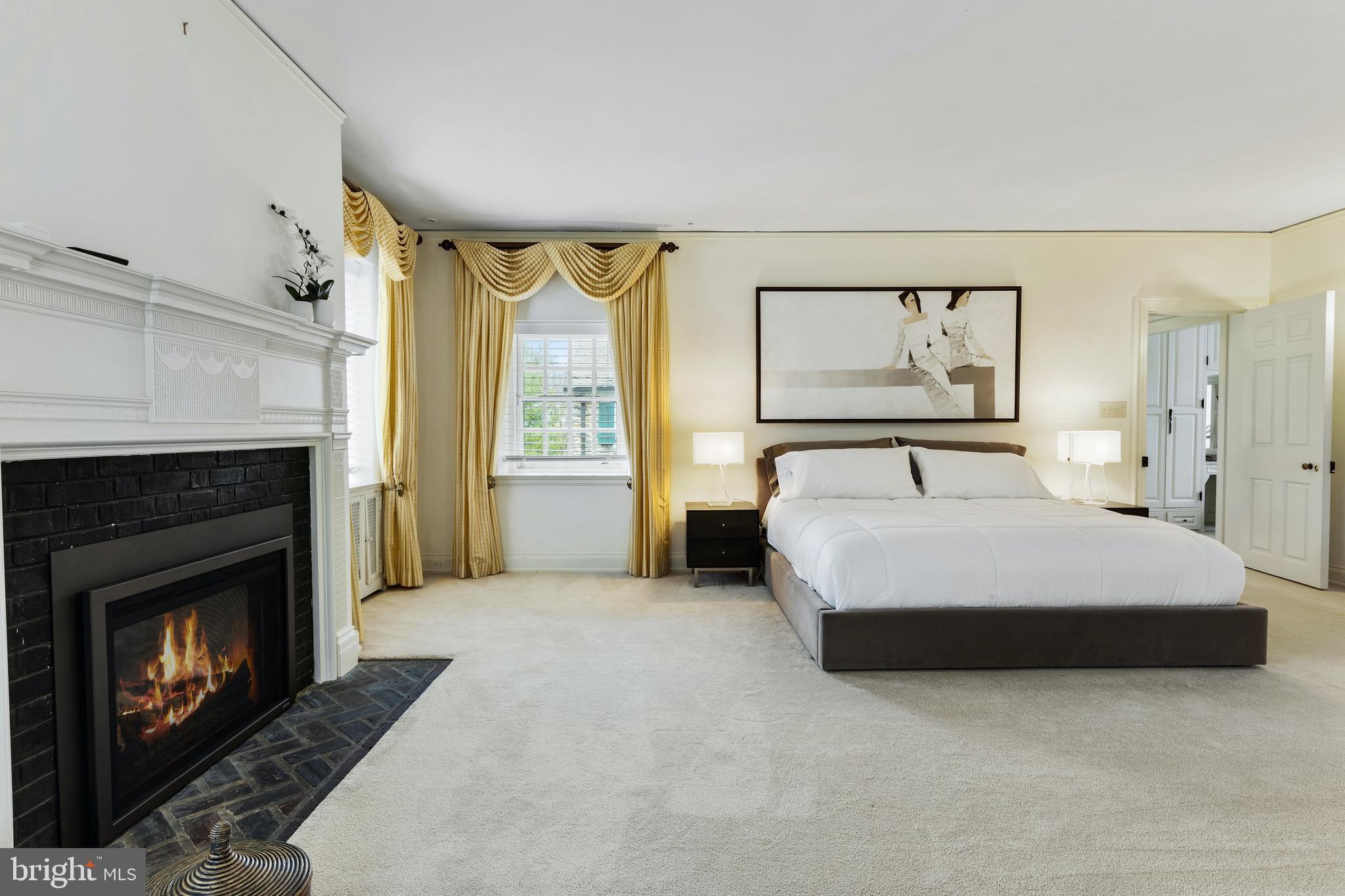 8201 Fenton Road Glenside, PA 19038 - Photo 65 of 86 a spacious bedroom with a bed and a fireplace