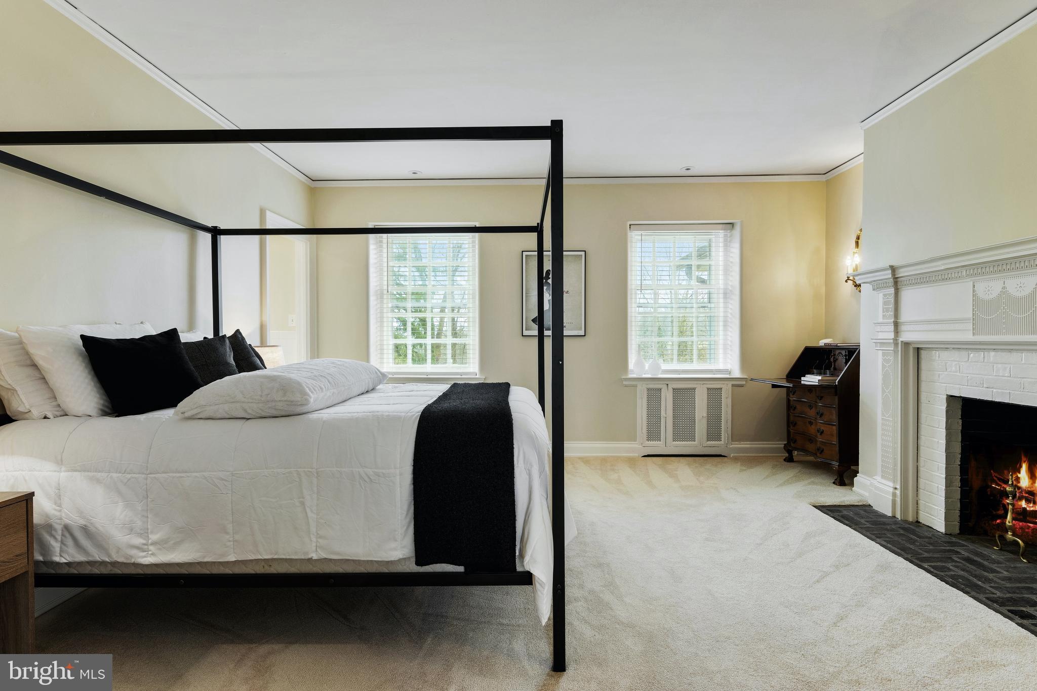 8201 Fenton Road Glenside, PA 19038 - Photo 74 of 86 a bedroom with a bed a fireplace and a large window