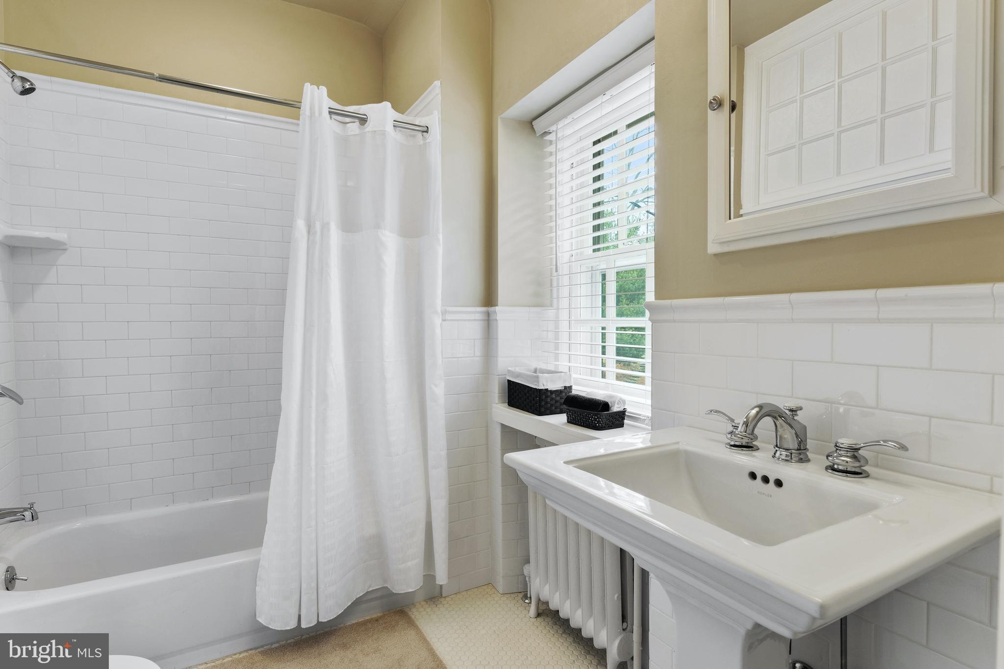 8201 Fenton Road Glenside, PA 19038 - Photo 80 of 86 a bathroom with a sink a mirror and a shower