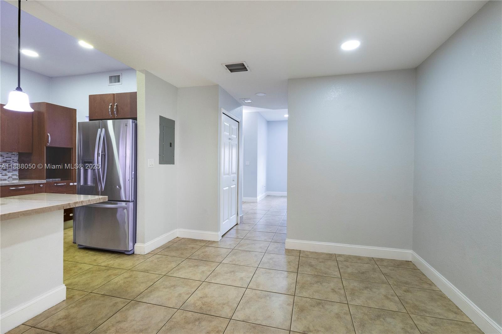 18038 Northwest 74th Court Hialeah, FL 33015 - Photo 11 of 39 a view of kitchen with refrigerator and cabinets