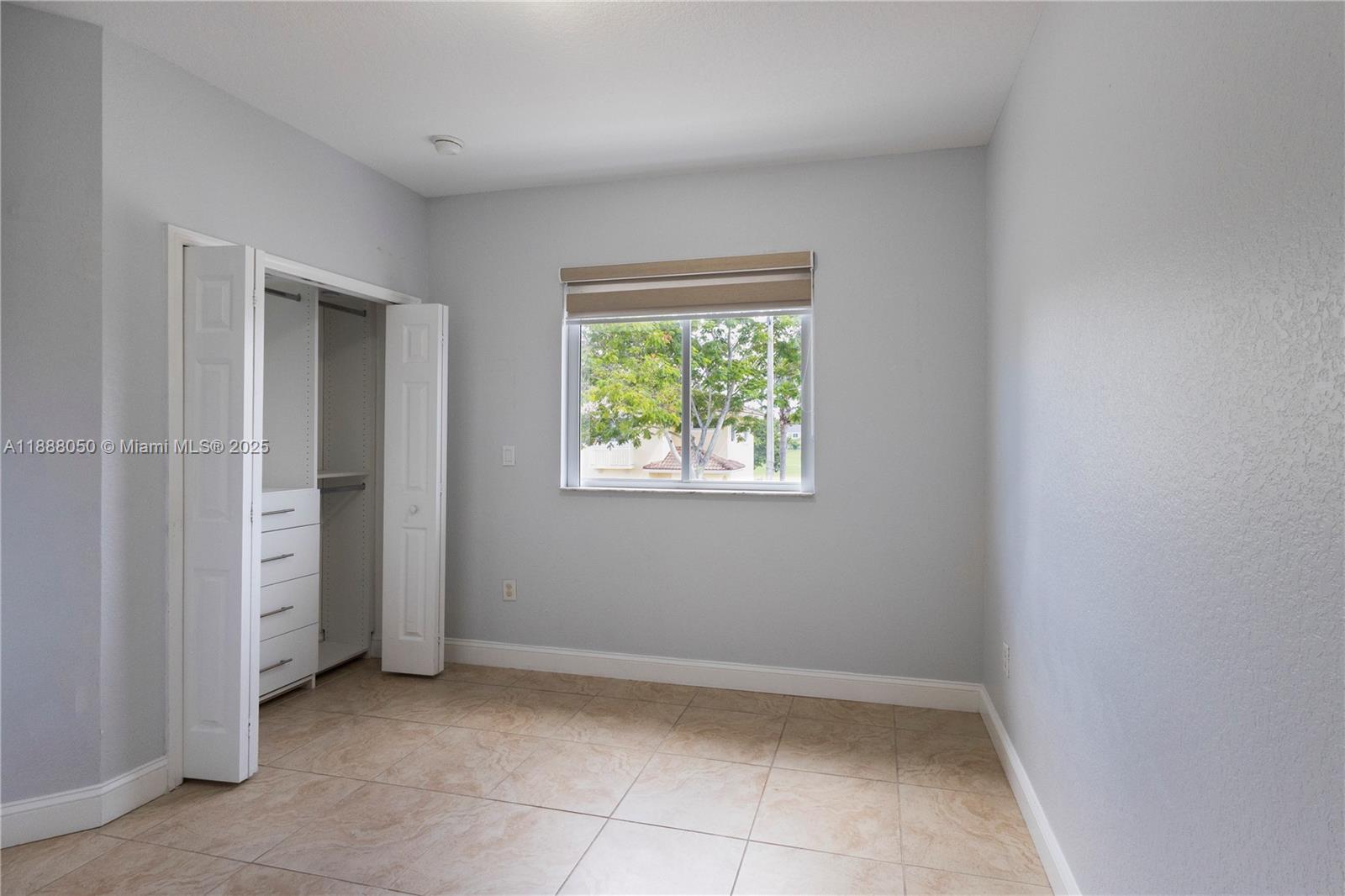 18038 Northwest 74th Court Hialeah, FL 33015 - Photo 20 of 39 an empty room with windows
