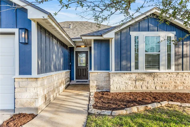a front view of a house with a large window