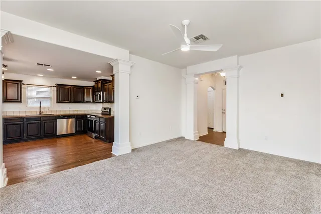 a view of a kitchen with a sink and a large window
