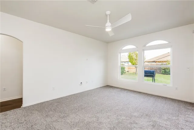 an empty room with windows and outdoor view