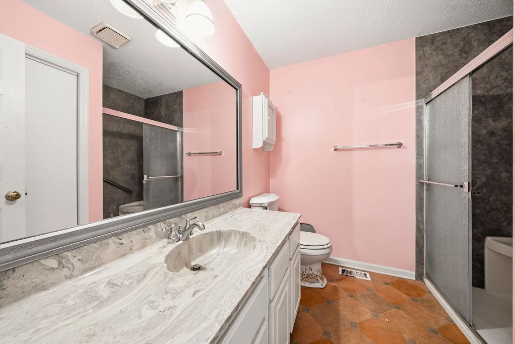 483 Allgood Road Flintstone, GA 30725 - Photo 17 of 34 a bathroom with a granite countertop sink toilet and shower