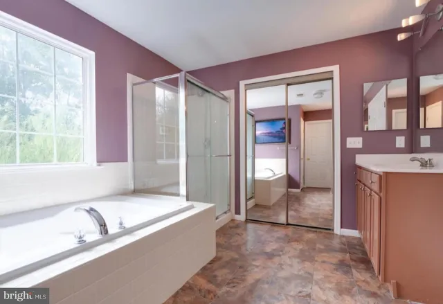 a spacious bathroom with a granite countertop tub and a sink
