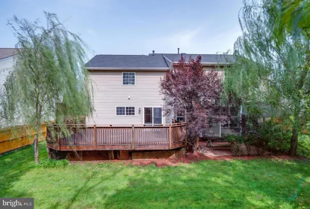 a view of a house with a backyard and a patio
