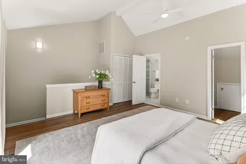 a bedroom with a balcony a bed and a window