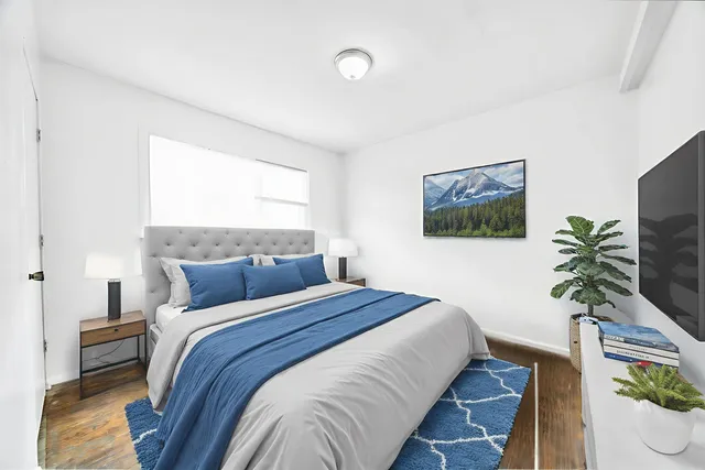 a bedroom with a bed and a flat screen tv